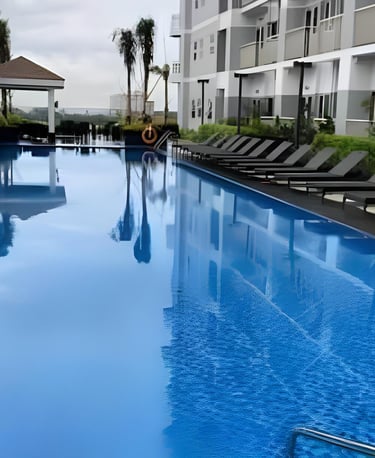 a pool with lounge chairs and lounge chairs