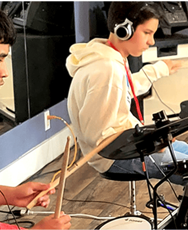 Teens drumming on electric drums