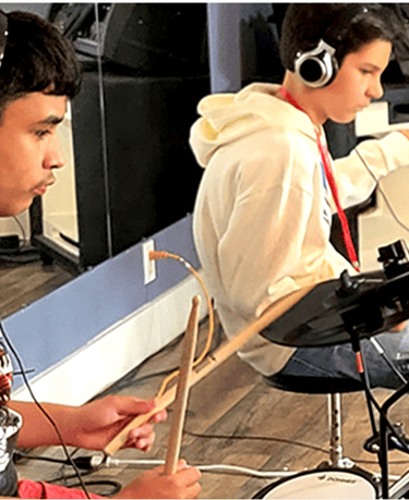 Teens drumming on electric drums