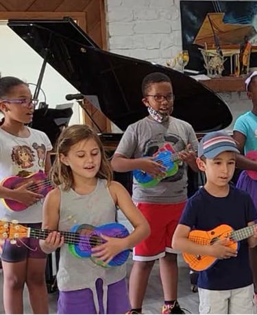 a group of children playing ukulele and singing