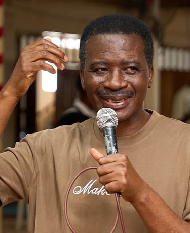 a man in a brown shirt is holding a microphone