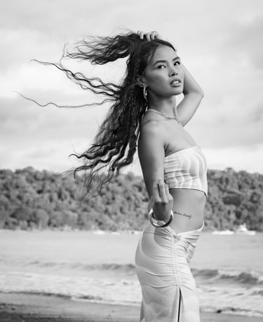 portrait of a woman in a white dress standing on a beach in costa rica