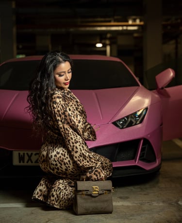 Model posing in leopard outfit beside pink Lamborghini, captured by Fred Art Studio