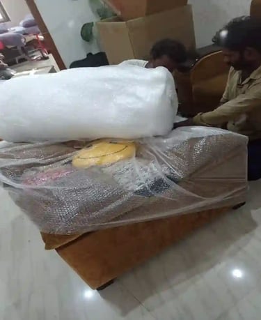 Seemanchal Packers & Movers staff carefully packing a sofa with bubble