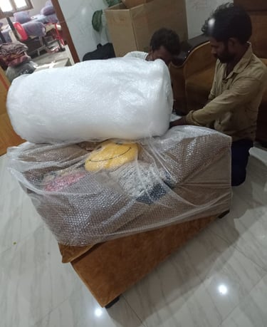 Seemanchal Packers & Movers staff carefully packing a sofa with bubble