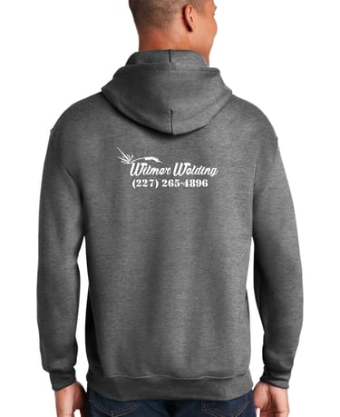 a man in a gray shirt and glasses is smiling