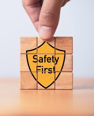Building blocks with the graphic of a yellow shield saying "Safety First" on the front