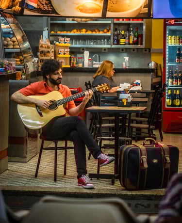 a man playing guitar in a restaurant