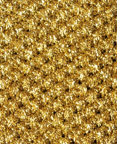 Close-up of the golden mesh cover of the Calipsi toothpaste dispenser, crafted with premium material