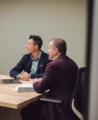 Men at a table discussing investment strategy