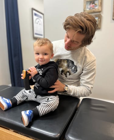 Smiling baby after a gentle chiropractic adjustment at Three Nails Chiropractic