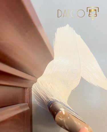 a person painting a wall with a paintbrush