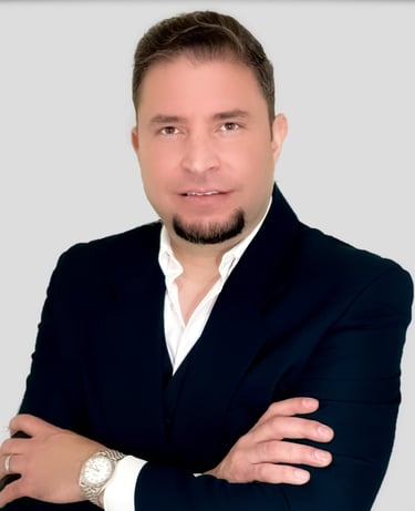 a man in a suit and white shirt and wearing a watch