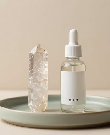 A clean, minimalist product photograph featuring a translucent alum crystal stick and a glass bottle of alum body mist. They are arranged on a light olive green ceramic tray, illuminated by soft natural light. The background is a clean beige plaster wall, evoking tranquil eco-luxury for North American and European Eco-conscious consumers.