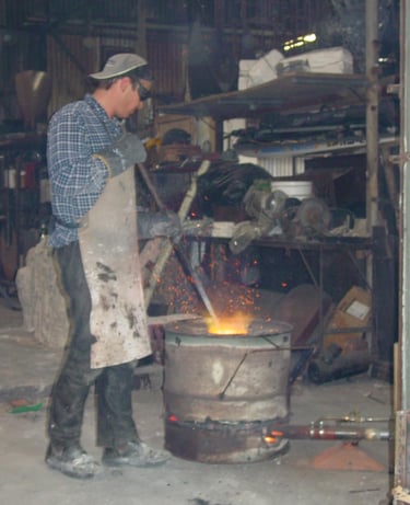 Matt stirring the bronze in the crucible