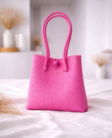 Handwoven fuchsia pink plastic tote bag handmade from recycled materials by Indonesian artisans