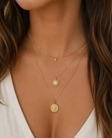 Layered gold necklace set featuring a dainty diamond, sun pendant, and vintage coin charm.