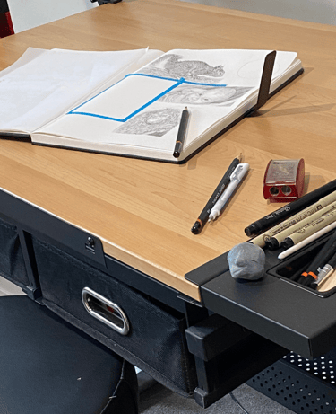 a desk with a sketchpad on top