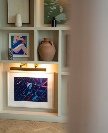 multiple art collection on the wall with vases