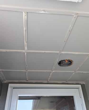 Trim boards nailed to a front porch ceiling