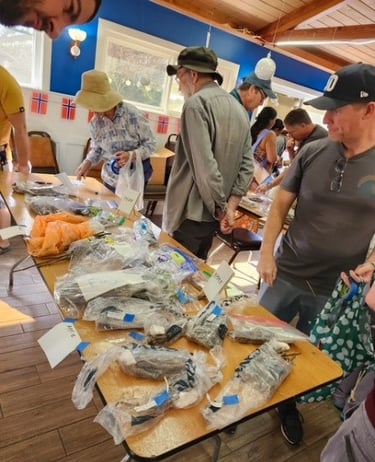 People browsing tables of bagged plant cuttings