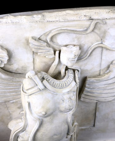 Closeup of small ceramic wall sculpture of nude woman with snakes and fragmented Greek Archaic-style wings.
