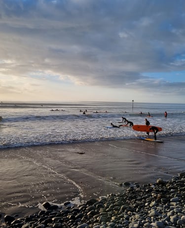An evening surf lesson at Ynyslas, with big clean waves and lots of surfers enjoyig the sea.