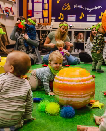 a group of mini moo children playing with toys for space week.