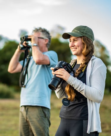 Guests on safari with camera and binoculars