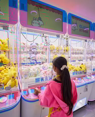 Young girl playing claw machines