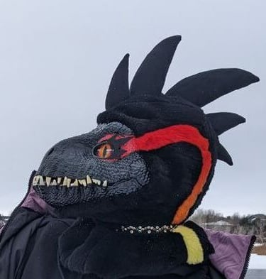 A incorporator fursuit Dino mask made by Teto Creations Featuriong a line of horns, 3d printed eyes and a painted gradient