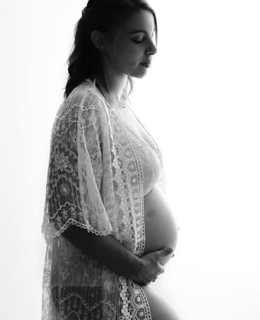 a pregnant woman in a white robe and a white robe