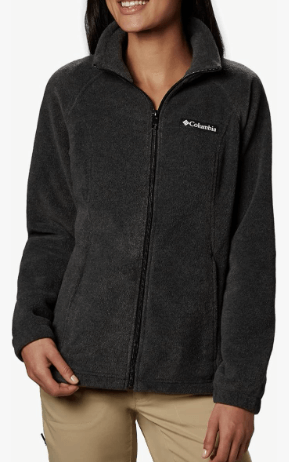 a woman wearing a black jacket and tan pants