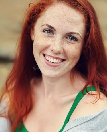 a woman with red hair and a green top