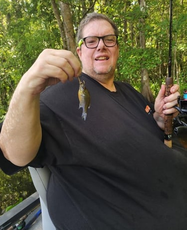 Paul holding a small bream