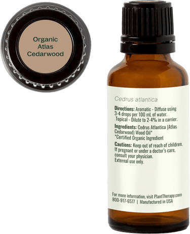 Organic Atlas Cedarwood bottle showing label with usage directions, cautions and cap