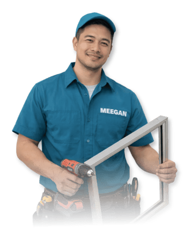 a professional glass fabricator and installer in a blue shirt holding an aluminum window frame