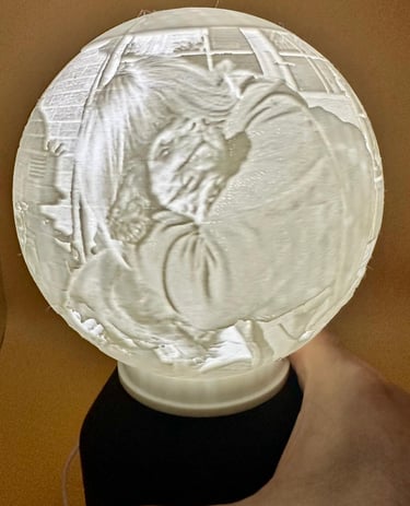 A 3D printed lithophane globe lamp showing a detailed portrait when illuminated from within.