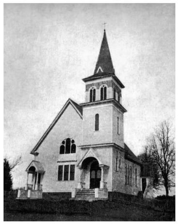 black and white photo of a church with a steeple
