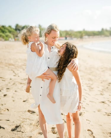 Mother and daughter sharing a joyful embrace during a family photography session at Ayodya Resort Bali