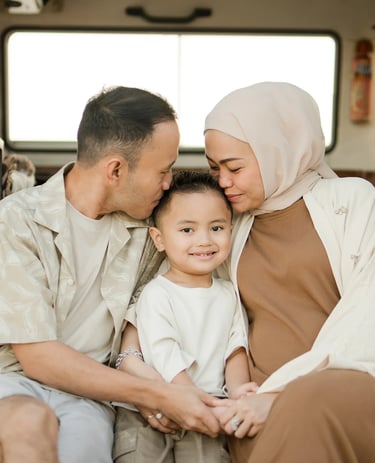 Tender family moment inside a retro combi van during Ilham family photography session at Melasti Beach Bali