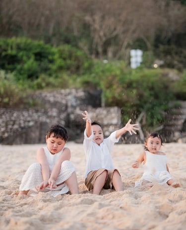 Playful candid moment of Ilham family children during a relaxed beach family photography session in Bali