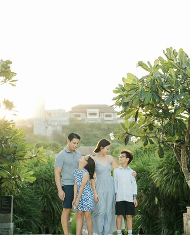 Family standing together on a resort pathway during a luxury family photography session at The Ritz-Carlton Bali.