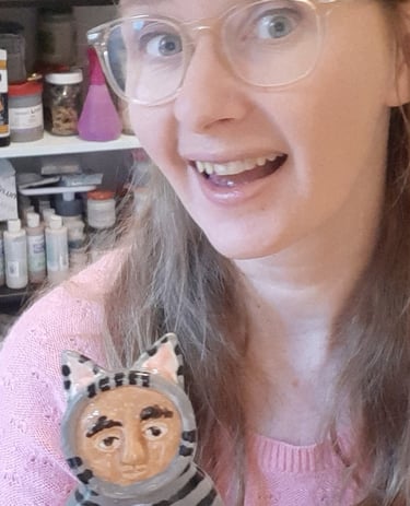 guusje smit creator of the smitties holding a ceramic figurine