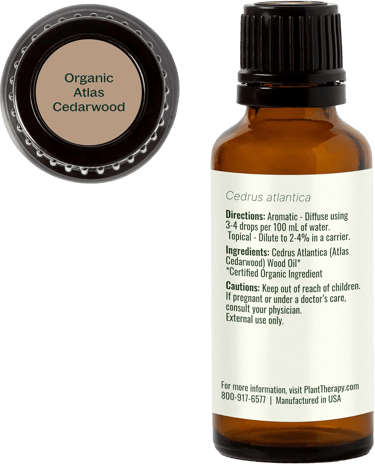 Organic Atlas Cedarwood bottle showing label with usage directions, cautions and cap