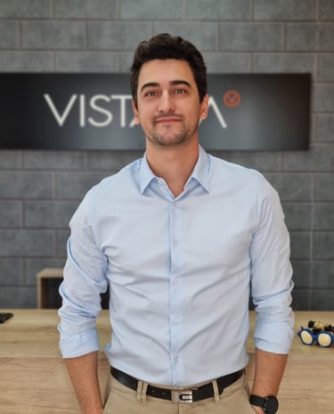 a man in a blue shirt and tan pants