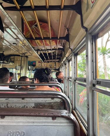 People sitting inside a local bus, known as a chicken bus, in Guatemala.