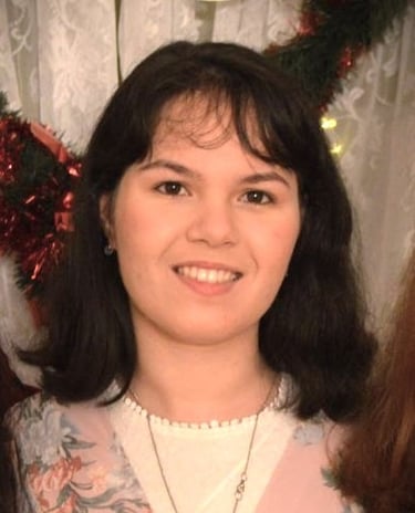 a woman in a floral dress smiling for the camera