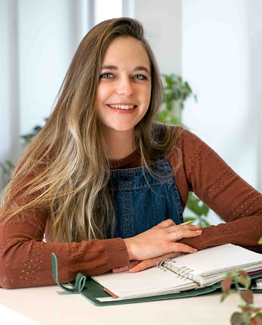 a woman sitting at a desk with a notebook