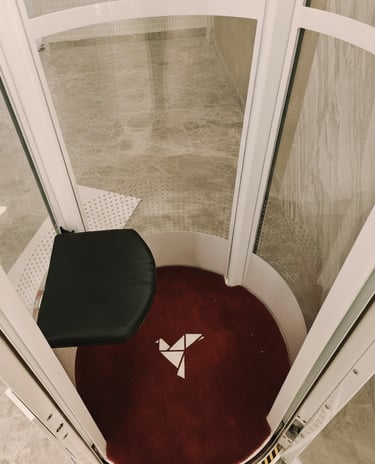 Interior view of vacuum home elevator cabin with seating in Jaipur residence